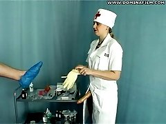 Perverted nurse stretches her male patients ass with a massive strapon toy