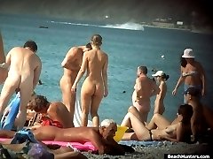 Hot parade of tanned nude bodies filmed on a beach