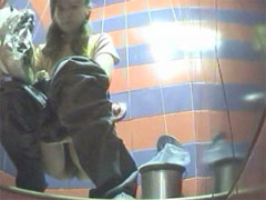 Two babes pissing in a spycammed beach toilet