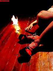 slim Eurasian girl in red fishnet Satanic flames
