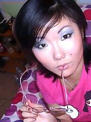 Nice Asian babe raise shirt to show her tits before her fingers caress her pussy