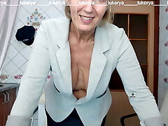 Lukerya tries on a jacket to a mini-skirt, displays naked boobs