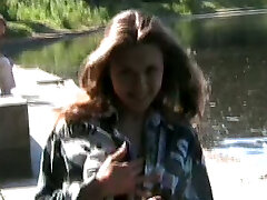 Fantastic lusty young stunner shows off her big udders and sexy ass by the lake