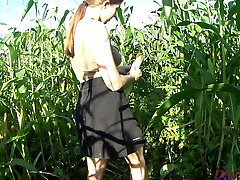 Kate Wood plays with her cootchie in a cornfield