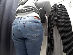 In a fitting guest room in a public store, the camera caught a round milf with a gorgeous ass in transparent panties. PAWG.