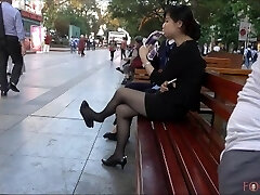 Chinese Office Lady having a break and dangling her high-heeled slippers