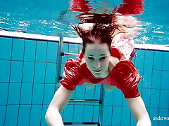 Cute babe in red killer open dress swimming