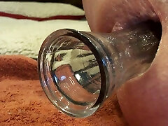 Close up anal insertion gape toy fake penis butt plug