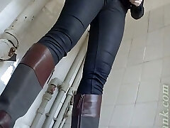 Pale skin blonde chick in boots pisses in the toilet
