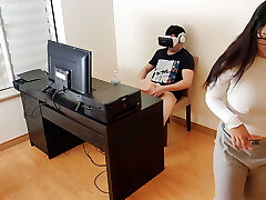 Steamy stepmother masturbates next to her stepson while he witnesses porn with virtual reality glasses