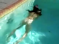 Sweet and sexy brunette teen babe in ebony bikini stripteases and jerks by the pool
