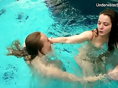 Two lovely chicks are all bare while swimming together underwater