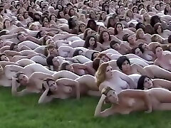 5000 nude people laying out for the camera operator who makes books