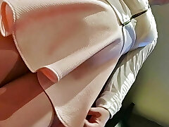 Lifting the miniskirt of a hot and horny schoolgirl.