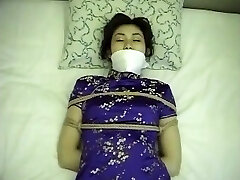 Chinese dress woman tied up and ball-gagged