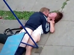 Drunk couple romping in the playground