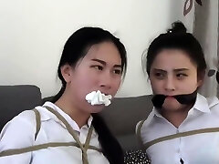 Chinese secretaries in white shirts are thoroughly gagged