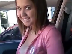 Happy young babe in the car flashes her stunning tits