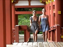 Lesbian couple kissing and showcasing at a Japanese temple