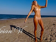 Naked Workout on the beach - a beautiful skinny milf with small milk cans