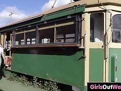 Two lesbian BBWs make out in antique tram carriage