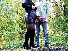 Milf in leather miniskirt gets a load on her ass outdoors