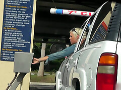 Big-boobed cute milf gets picked up in the car wash and displays her tits