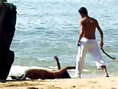 Getting whipped and fucked right on the beach makes this submissive brunette cum hard