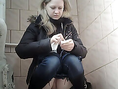 Sweet pale skin blonde teenie in blue denim urinates in the toilet