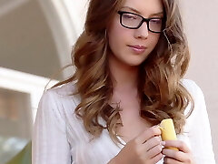 Sexy girl in glasses sucks a banana as she wanks