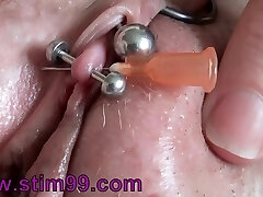 Real Clitoris piercing and through with a needle