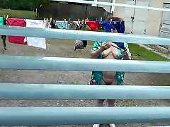 Naked in public. Neighbor saw pregnant neighbor in window who was drying clothes in yard sans brassiere and underpants. Nudist
