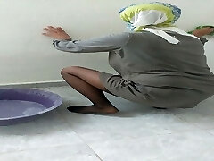 Hijab female cleaning kitchen