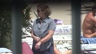 Mature mom with chubby body and saggy cupcakes is putting on lotion sunbathing nude