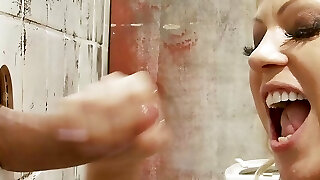 Desperate towheaded milf with fake boobs waits inside the gloryhole for a massive cock to deepthroat and fuck