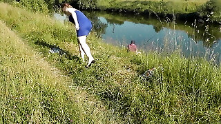 Nudist beach. Public nudity. Fabulous MILF without panties and bra sunbathes naked is not shy about fisherman. Naked in public. Milf