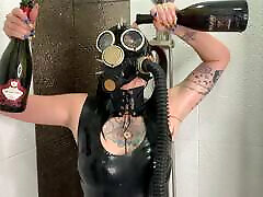 Dominatrix Nika in a gas mask pours wine over her latex body. daugher tube fetish