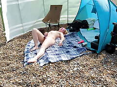 A young blonde wife is polie sex and masturbating on a British public beach