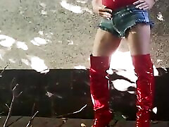 Slutty Cd Bella plays outside in red swimsuit and sexy boots