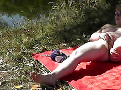 MILF solo. Wild beach. Public nudity. Sexy sex done in different positio on river bank fingers wet pussy and has strong orgasm. Naked in public. Outdoors