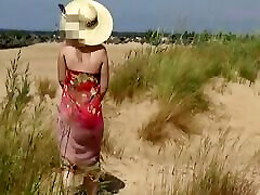 Naked hot MILF on a nude beach.