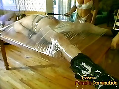Two luscious harlots wrap a dude in more pussy foil and tease