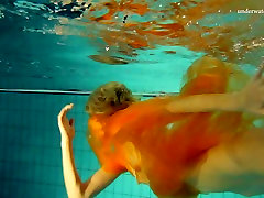 Slim blonde angel Nastya swimming naked in a pool