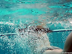 Busty teen Piyavka Chehova swimming in a pool like a mermaid