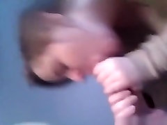Cute ponytailed brunette girl gives her bf a doll european blowjob and handjob, while sitting on her bed.