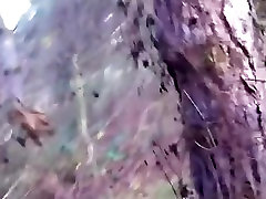 Streetslut sucks off a guy in the forest, until he cums in the condom.