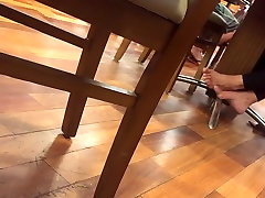 Candid mature barefeet in food court