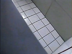 A blonde is pissing in the college toilet