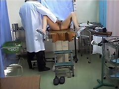 Asian schoolgirl stretches oilled ass butt in the gyno office