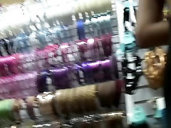 Slim girl in black dress was filmed in the shop by the spy camera
